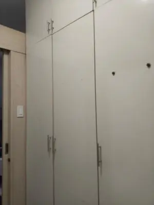 a group of four white cabinets in a room at MOA Sea Residences Condo in Manila