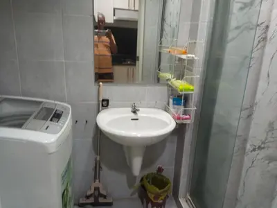 a bathroom with a sink and a shower at MOA Sea Residences Condo in Manila