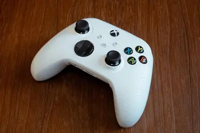 a white video game controller sitting on a table at Uptown BGC Spacious Unit - 1 Queen bed and Bunkbed in Manila
