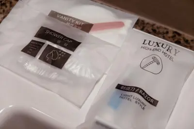 a package of lipstick and other items on a sink at Uptown BGC Spacious Unit - 1 Queen bed and Bunkbed in Manila