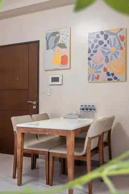 a dining room with a table and chairs at Uptown BGC Spacious Unit - 1 Queen bed and Bunkbed in Manila