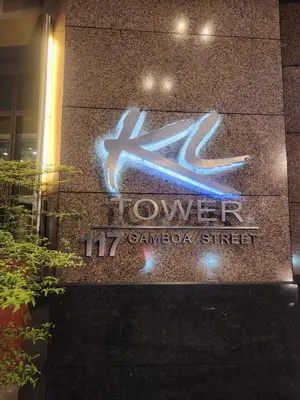 a sign on the side of a building at KL Tower Cosy Studio with City and Park View in Manila