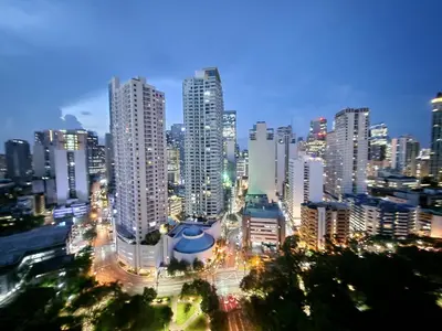 a city skyline at night with tall buildings at KL Tower Cosy Studio with City and Park View in Manila