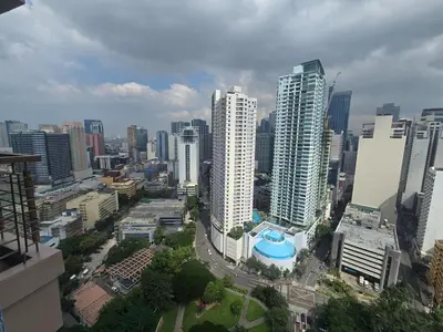 a view of a city with tall buildings at KL Tower Cosy Studio with City and Park View in Manila