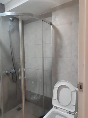 a bathroom with a toilet and a shower at BS651 Room with Balcony and free pool in Manila