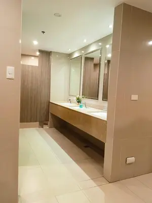 a bathroom with two sinks and two mirrors at BS651 Room with Balcony and free pool in Manila