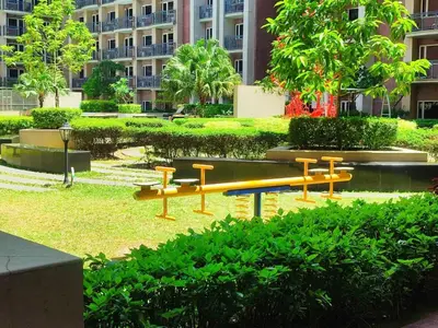 a park with benches in front of a building at BS651 Room with Balcony and free pool in Manila
