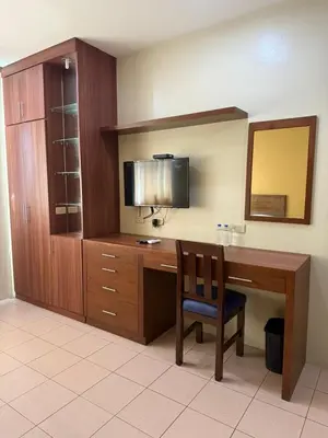 a room with a desk with a tv and a chair at Joyce Apartelle Mandaluyong in Manila