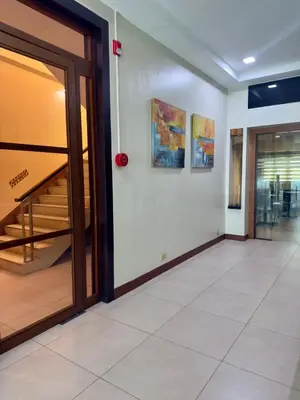 an empty hallway with an open door and stairs at Joyce Apartelle Mandaluyong in Manila