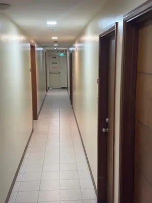 a hallway with a long corridor with two doors at Joyce Apartelle Mandaluyong in Manila