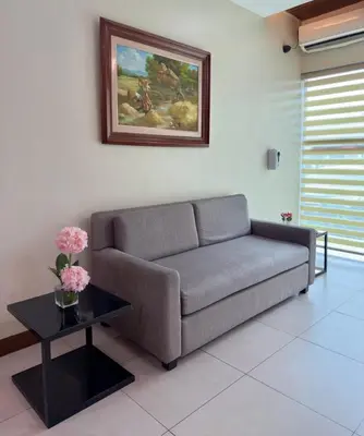 a living room with a couch and a table at Joyce Apartelle Mandaluyong in Manila