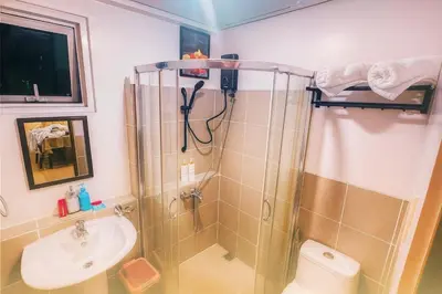 a bathroom with a shower and a sink and a toilet at The Beacon Skyview 2BR La Suitez4307 in Manila