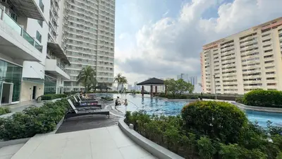a swimming pool in the middle of a city with buildings at The Beacon Skyview 2BR La Suitez4307 in Manila
