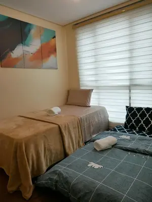a bedroom with two beds and a window at The Beacon Skyview 2BR La Suitez4307 in Manila