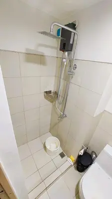 a bathroom with a shower and a toilet at Staycation in Manila near NAIA Airport in Manila
