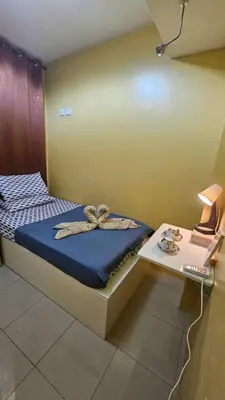 a bedroom with a bed with a bow on it at Marbella Tower 2 in Manila