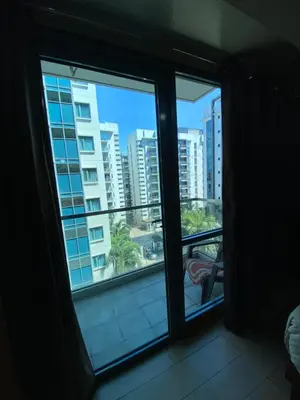 a room with a window with a view of a city at the palm tree villas by kath in Manila