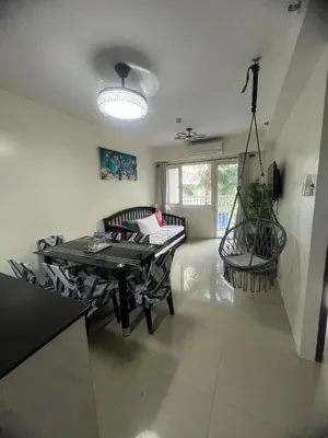 a living room with a table and a couch at 2Br Suite Shore Residences by JMS in Manila