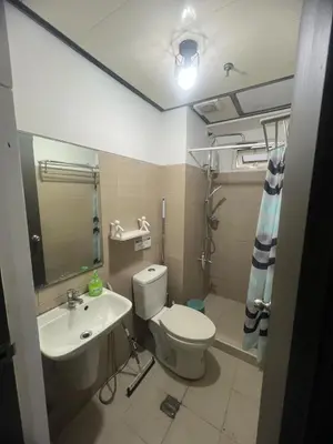 a bathroom with a toilet and a sink at 2Br Suite Shore Residences by JMS in Manila