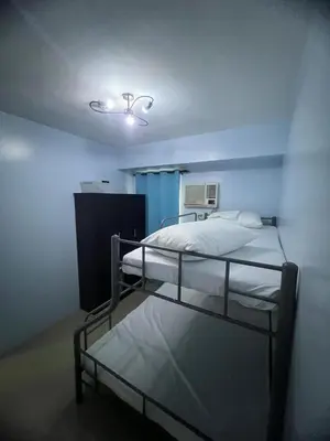 a room with two bunk beds and a light at 2Br Suite Shore Residences by JMS in Manila