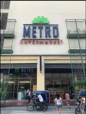 a metro supermarket sign on the side of a building at JRM Staycation Naia T3 C66E in Manila