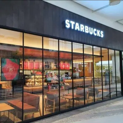 a store front of a starbucks with tables and chairs at JRM Staycation Naia T3 C66E in Manila