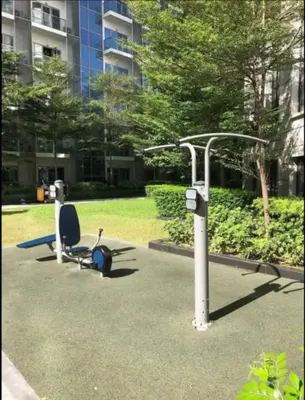 a park with a bench and a machine at JRM Staycation Naia T3 C66E in Manila