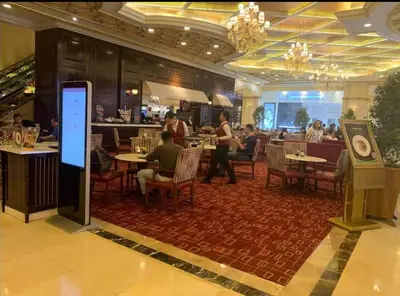 a restaurant with people sitting at tables and a bar at JRM Staycation Naia T3 C66E in Manila