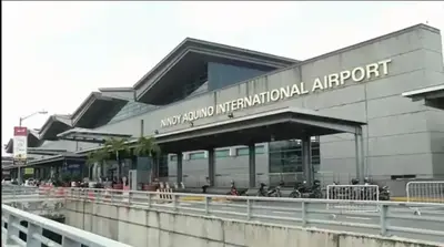 a building with a sign for an international airport at JRM Staycation Naia T3 C66E in Manila