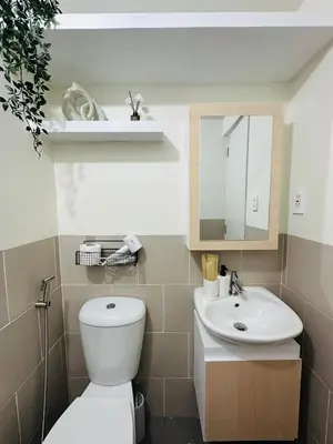 a bathroom with a white toilet and a sink at Getaway Haven at Southwoods, Biñan with Fast Internet in Biñan