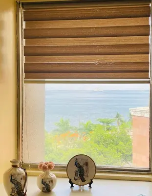 a window with a view of the ocean at He Condotel Bell in Manila