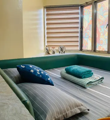 a bed in a room with pillows and a window at He Condotel Bell in Manila