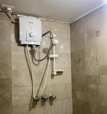 a shower in a bathroom with a tank and a shower at He Condotel Bell in Manila