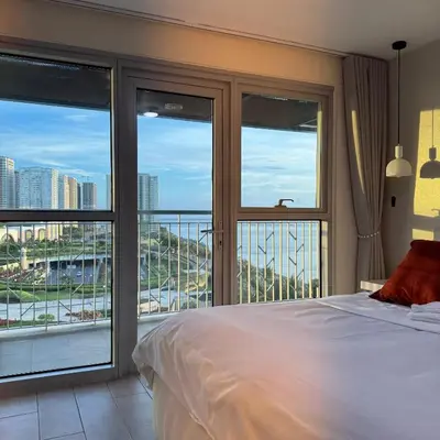 a bedroom with a bed and views of a city at Panoramic Landscape and Seaview, 2BR, Near Airport, 8m in Manila
