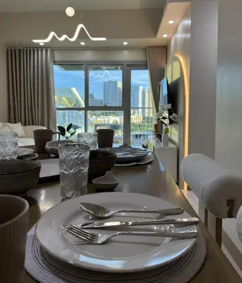 a dining room table with plates and silverware on it at Panoramic Landscape and Seaview, 2BR, Near Airport, 8m in Manila