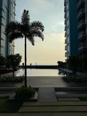 a palm tree sitting next to a body of water at Panoramic Landscape and Seaview, 2BR, Near Airport, 8m in Manila