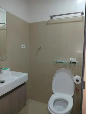 a bathroom with a white toilet and a sink at Condo Next Door PH in Manila