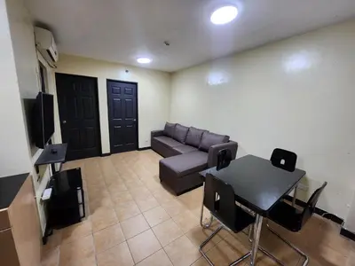 a living room with a couch and a table at 2BR Condo near BGC in Manila