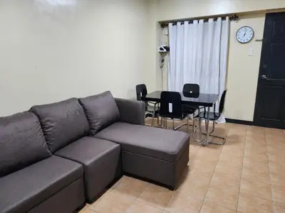 a living room with a couch and a table at 2BR Condo near BGC in Manila