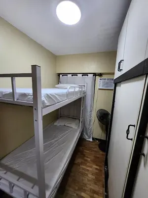 a small room with two bunk beds in it at 2BR Condo near BGC in Manila