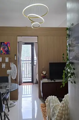 a living room with a table and a chandelier at SMDC Red Residences Makati w own parking slot in Manila