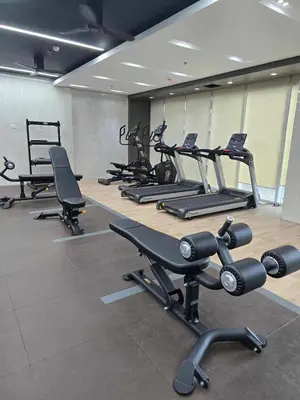 a gym with a row of treadms and cardio machines at SMDC Red Residences Makati w own parking slot in Manila