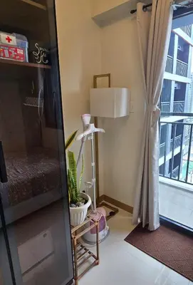 a living room with a lamp and a window at SMDC Red Residences Makati w own parking slot in Manila