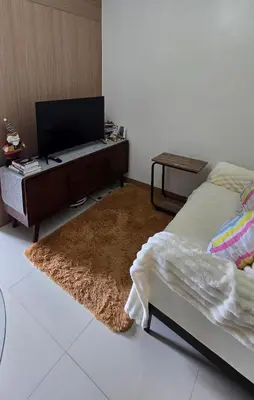 a bedroom with a bed with a desk and a rug at SMDC Red Residences Makati w own parking slot in Manila