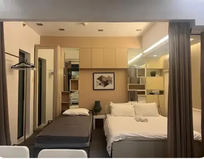 a bedroom with two beds and a mirror at 1BR Grand Riviera Suites by MrSayla in Manila