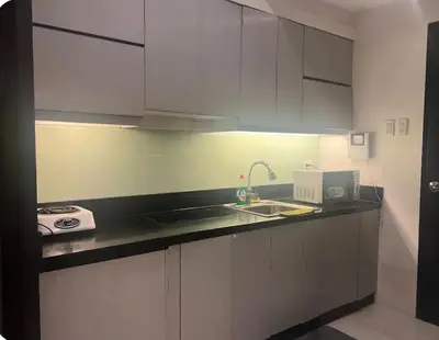 a kitchen with a sink and a counter top at 1BR Grand Riviera Suites by MrSayla in Manila