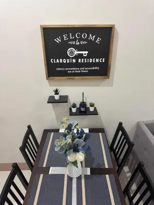 a dining room table with a vase of flowers on it at Clarquin Residences - Shore 3 Residences Tower 2 in Manila