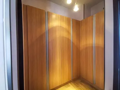 a closet with wooden doors and a wooden floor at Bayshore Staycation in Manila