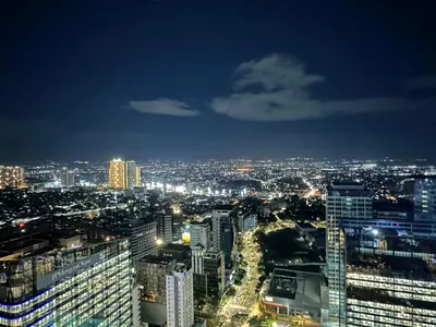 a view of a city at night at Spacious Modern Suites with Amazing City View in Manila