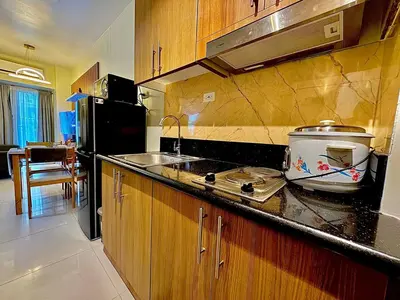 a kitchen with a sink and a counter top at Shore 3 Residences - HTZ Haven in Manila
